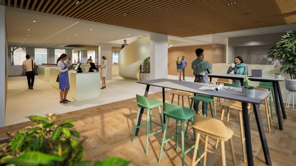 Modern reception area of De Entree with people interacting, working, and walking around in a bright, open space.